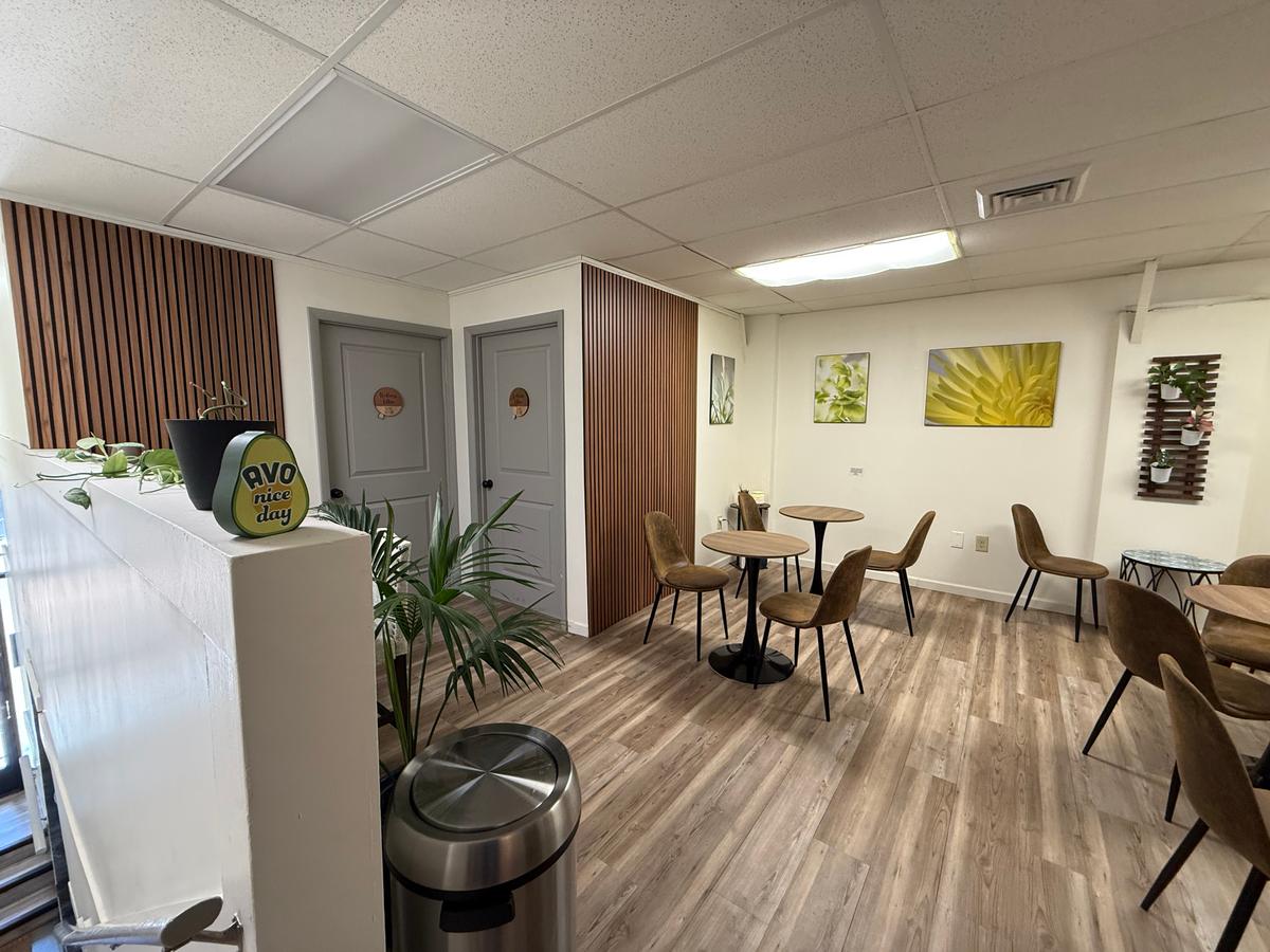 Cozy café corner with tables, chairs, and wall art featuring food images